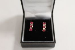 A pair of 9ct gold ruby and diamond earrings. (2) CONDITION REPORT: Good condition.