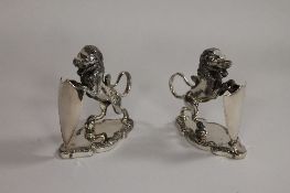 A pair of silver plated Lion epergne holders by Walker & Hall, height 12.5 cm. (2) CONDITION REPORT: