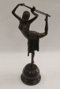 After Demetre Chiparus - An Art Deco style dancer with hoop, bronze study on black marble base,