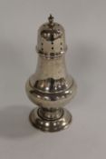 A silver sugar caster, height 16.5 cm. CONDITION REPORT: Good condition, hallmarks rubbed, early