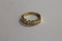 An 18ct gold seven stone diamond half eternity ring. CONDITION REPORT: Good condition.