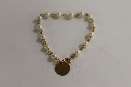 A 14ct gold pearl bracelet. CONDITION REPORT: Good condition, stamped 14k, small size probably a