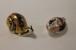 Two Royal Crown Derby English bone china paperweights : Garden Snail, height 7 cm, and Quail, height