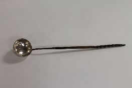 A Georgian silver toddy ladle. CONDITION REPORT: Some time aged knocks and bumps, the rim