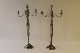 A large pair of white metal candelabra, height 146 cm. (2) CONDITION REPORT: Good condition.