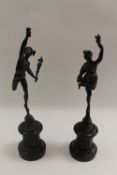 A pair of French bronze figures depicting Icarus and companion, on black slate plinths, height 52