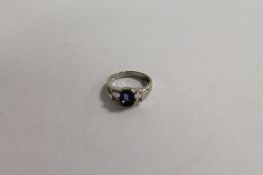 An 18ct white gold sapphire and eight stone diamond ring. CONDITION REPORT: Good condition.