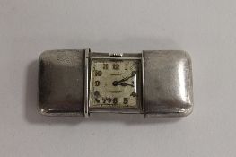 A sterling silver Movado Swiss Ermeto purse watch, width 7.5 cm. CONDITION REPORT: Good / Fair