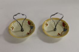 A pair of Clarice Cliff Newport Pottery bon-bon dishes. (2) CONDITION REPORT: With chrome handles,
