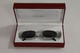 A pair of Cartier tinted spectacles, cased. CONDITION REPORT: Excellent condition.