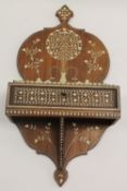 A nineteenth century Anglo Indian wall bracket, inlaid with ivory, fitted with a drawer, width 25