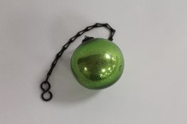 A nineteenth century green lustre witch ball on chain, diameter 8 cm. CONDITION REPORT: Good