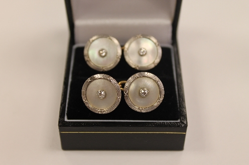 A pair of 9ct gold and Mother of Pearl cufflinks, each set with two diamond studs. CONDITION REPORT: