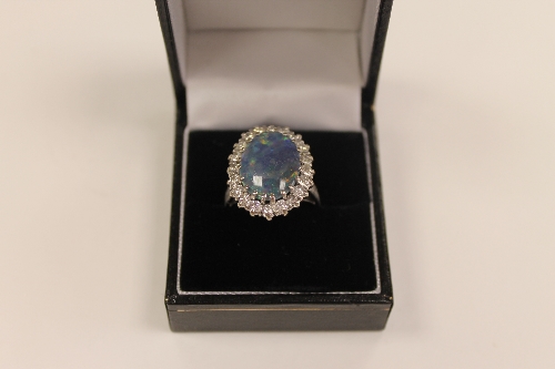 An 18ct white gold diamond and opal ring. CONDITION REPORT: Good condition.