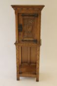 A carved oak cabinet, with gothic style panels, width 49.5 cm. CONDITION REPORT: Good condition,