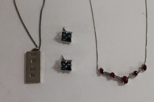 A sterling silver and ruby necklace, together with a silver ingot on chain, Sheffield 1976, and a