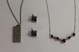 A sterling silver and ruby necklace, together with a silver ingot on chain, Sheffield 1976, and a