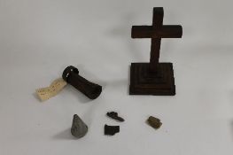 A WW II oak Army field communion crucifix, together with a tail-fin from an incendiary bomb, the
