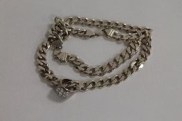 A sterling silver curb chain, together with a sterling silver ring. (2) CONDITION REPORT: Total