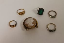 A 15ct gold ring, set with a small diamond, together with four dress rings and a cameo brooch. (6)