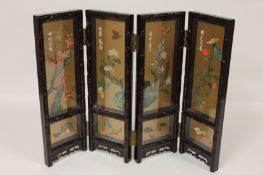 A Chinese lacquered miniature four-fold screen, width 60 cm. Good condition, glazed front with