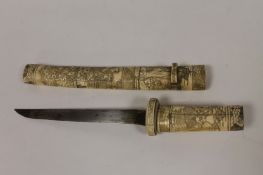 A nineteenth century Japanese tanto with bone mounts and scabbard. Good condition, blade length 21