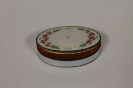 A continental enamel and white metal pill box, stamped .930. Good condition with gilt interior.