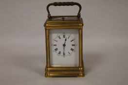 A French chiming brass carriage clock, height 12 cm. Requires some attention, visible the top