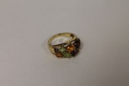 A 9ct gold citrine, peridot and garnet multi-stone ring. Good condition.