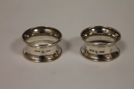 Two silver napkin rings, London 1911. (2) Good condition, italic engraved initials within a floral