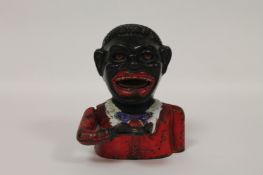 A cast iron money bank-Jolly Nigger, height 16.5 cm. Good time-aged condition with minor paint ware.