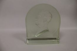 A green bevelled glass paperweight depicting a male bust, height 22.5 cm. Good condition, minor