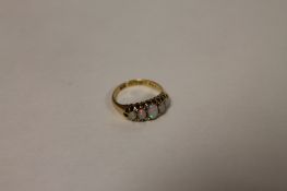 An 18ct gold five stone opal ring. Good condition.