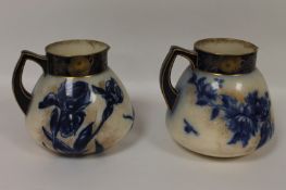 A pair of Doulton Burslem water jugs, height 19 cm. (2) Good condition, the heights vary just