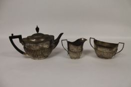 A silver three piece tea service, 31 oz. (3) A non matching service but matched by design. The sugar