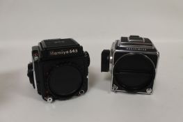 A Mamiya 645 100S, together with Hasselblad 500C/M, both camera bodies only, boxed. (2) Good