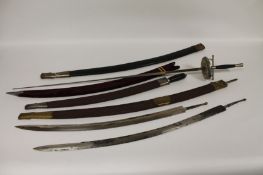 A group of four Indian sabre blades, some with scabbards, together with an ornamental foil. (7)