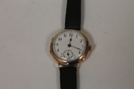 A 9ct gold Gentleman`s wrist watch. With white enamel dial in good condition on brown leather strap.