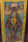 An antique Thangka, painted embroidery, 109 cm x 46 cm, framed. Unexamined out of the frame, fixed