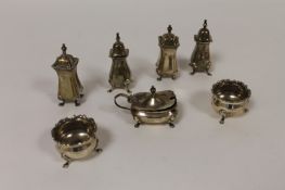 A pair of silver salts, Birmingham 1934, together with two pairs of silver pepper pots and a