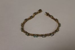 A 9ct gold blue topaz and diamond bracelet. Good condition.