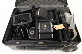 A Hasselblad 500 EL body, together with EL / M body with magazine and accessories, in Porter case.