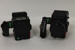 A Rolleiflex 608, with two camera bodies, three camera film backs, waist level view finder, three