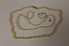Two straps of cultured pearls with 9ct gold clasps. (2) One set is graduated, the white gold clasp