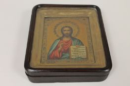 A continental icon on tin, held in a glazed frame, 17 cm x 21 cm. Fair condition, the frame with