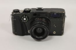 A Hasselblad Xpan camera, with wide angle and standard lens. (2) The camera case with minor time-
