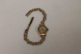 A 9ct gold Lady`s wrist watch by Tissot. 12.8g gross. Condition fair dial requires a clean.