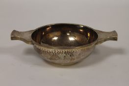 A silver quaich, Edinburgh 1926. With part hammered interior 224g.