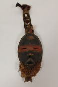 A Dan passport mask, with corrie shells. The Dan mask was used during initiation ceremonies they are