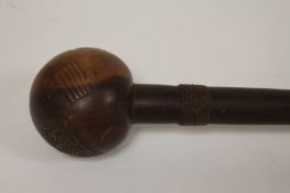 An antique knobkerry, length 85 cm. Good condition, time-aged ware and two age cracks to the ball.